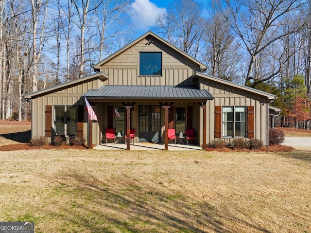 view of front of house featuring a front lawn and a patio