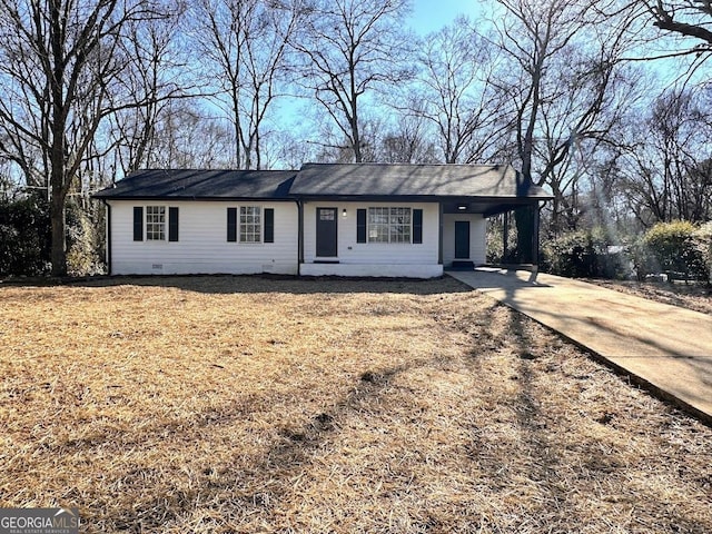 ranch-style house with a front lawn and a carport