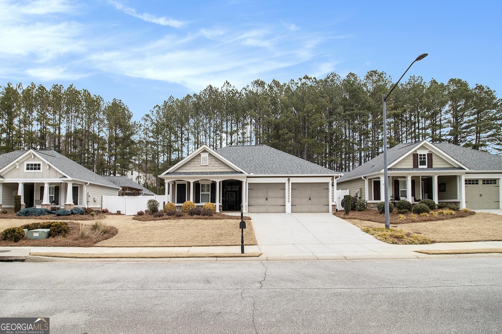 craftsman inspired home featuring a garage and covered porch