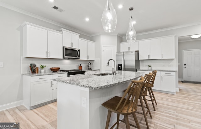 kitchen featuring white cabinetry and appliances with stainless steel finishes