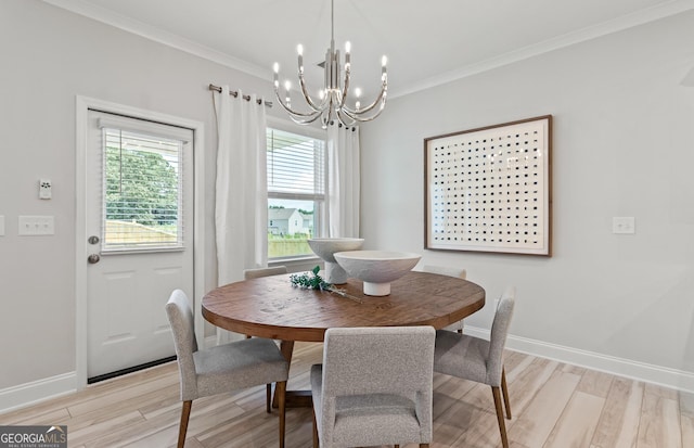 dining space featuring light wood-type flooring, crown molding, and a chandelier