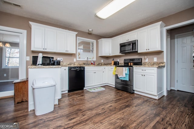 kitchen featuring white cabinetry, stainless steel appliances, dark hardwood / wood-style flooring, and light stone counters