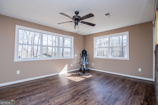 exercise area with dark hardwood / wood-style floors and ceiling fan