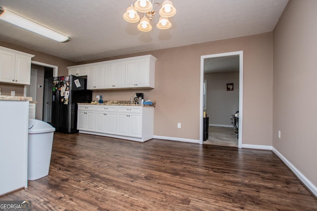 kitchen with dark hardwood / wood-style flooring, a chandelier, black refrigerator with ice dispenser, and white cabinets