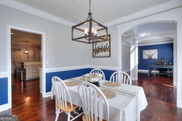 dining area featuring ornamental molding, a chandelier, and dark hardwood / wood-style flooring