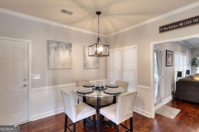 dining space with a chandelier, dark hardwood / wood-style flooring, and ornamental molding