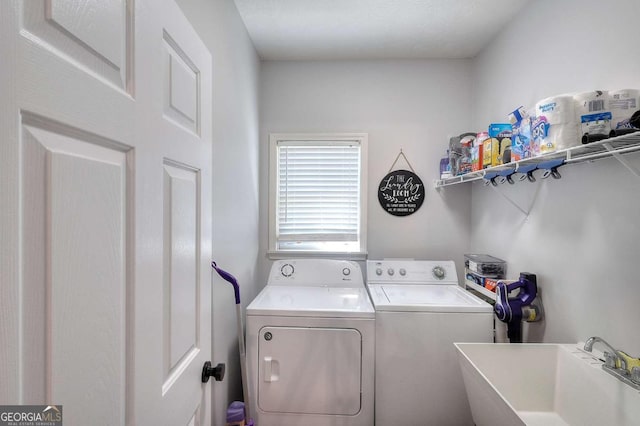 laundry room featuring washer and clothes dryer and sink