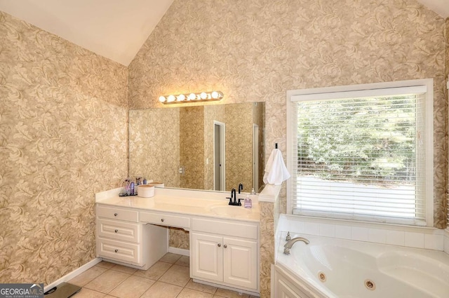 bathroom with vaulted ceiling, a bathtub, tile patterned floors, and vanity