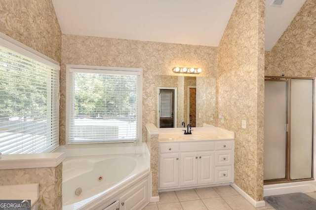 bathroom with tile patterned floors, vanity, plus walk in shower, and vaulted ceiling