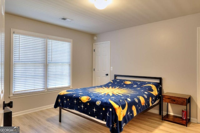 bedroom with hardwood / wood-style floors