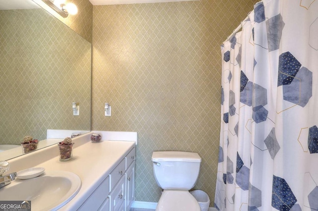 bathroom featuring toilet, vanity, and a shower with shower curtain