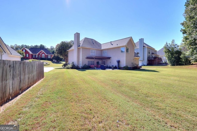 back of house featuring a lawn