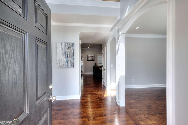 entryway with dark hardwood / wood-style flooring, ornamental molding, and ornate columns