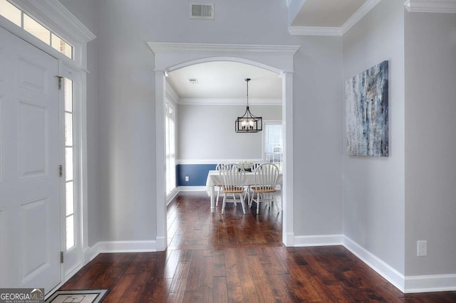 entryway featuring dark hardwood / wood-style floors, crown molding, and a healthy amount of sunlight