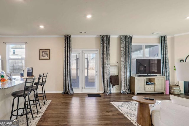 living room with dark hardwood / wood-style floors and crown molding