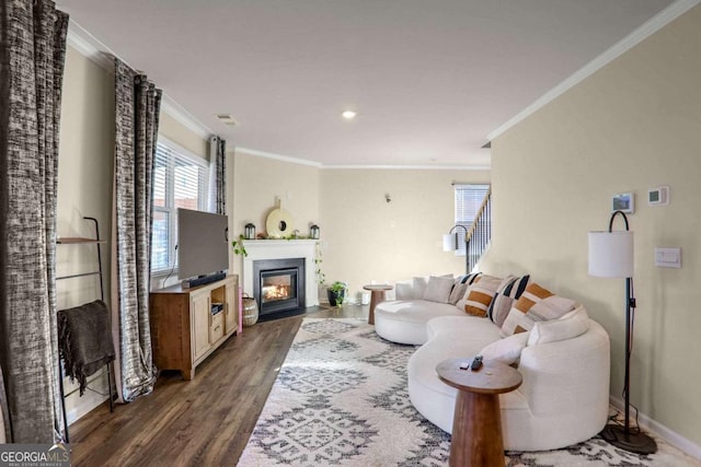 living room with dark hardwood / wood-style floors and crown molding