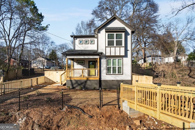 rear view of house featuring covered porch