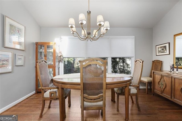 dining space featuring dark hardwood / wood-style floors and a notable chandelier