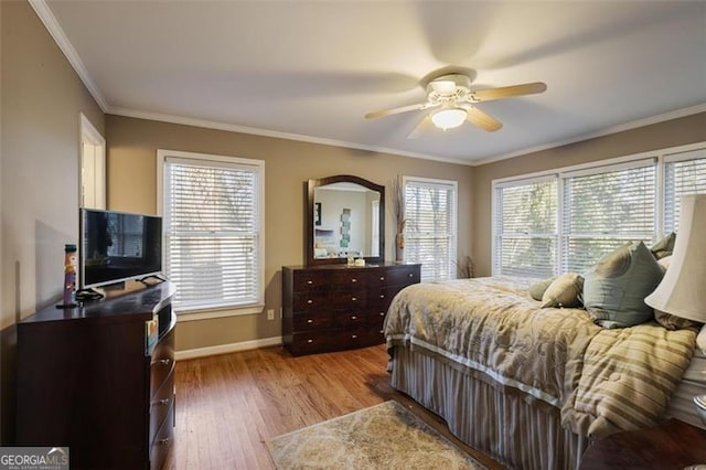 bedroom with ceiling fan, crown molding, and hardwood / wood-style floors