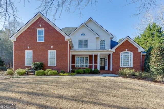 view of property with a front lawn and a porch