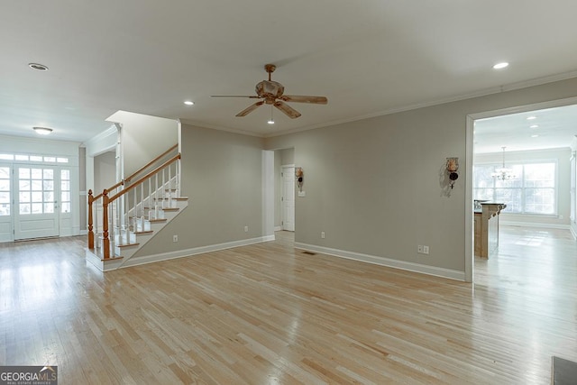 unfurnished living room with ceiling fan and ornamental molding