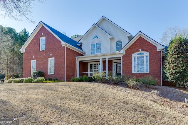 view of front property with a front lawn and a porch