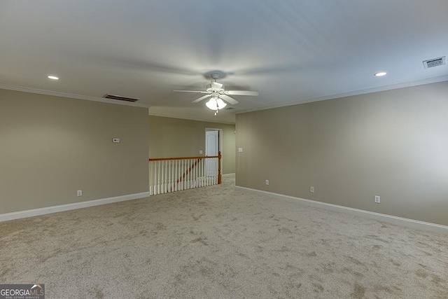 carpeted spare room featuring ceiling fan and ornamental molding