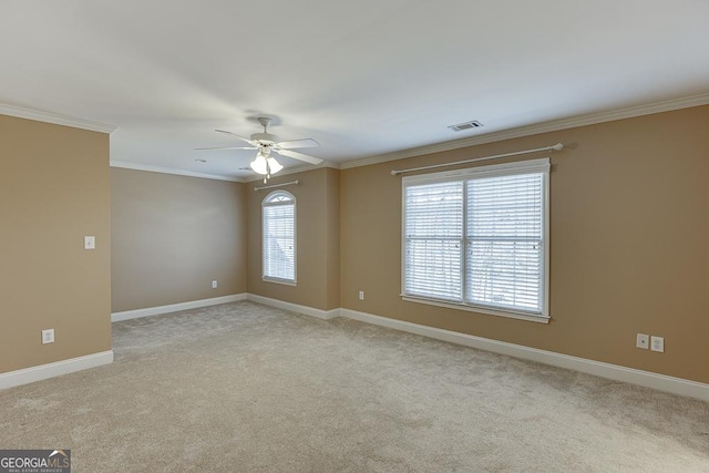 carpeted empty room featuring ceiling fan and ornamental molding