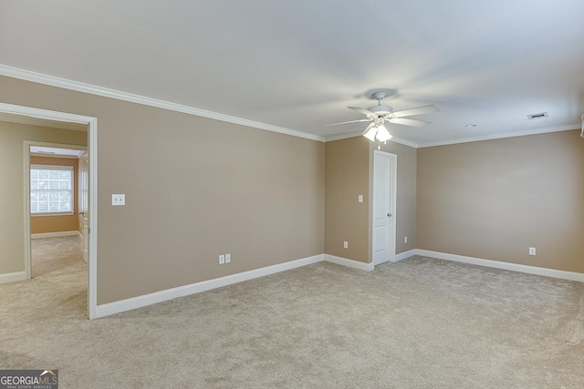 unfurnished room with ceiling fan, light carpet, and ornamental molding