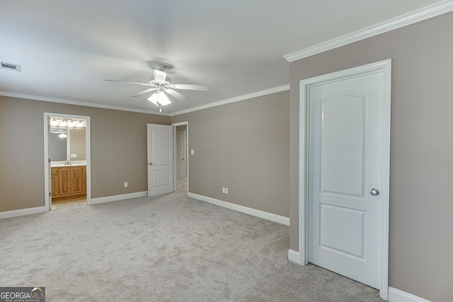 unfurnished bedroom with ceiling fan, light colored carpet, ensuite bath, sink, and crown molding