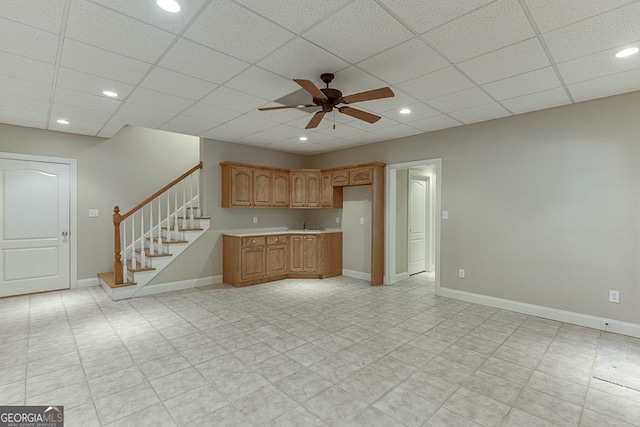 kitchen featuring ceiling fan and a paneled ceiling