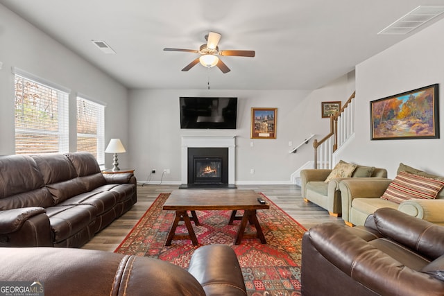 living room with light hardwood / wood-style floors and ceiling fan