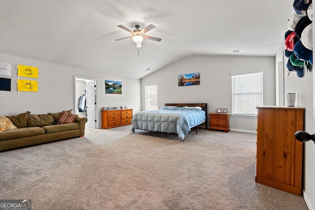 carpeted bedroom featuring ceiling fan, a spacious closet, and lofted ceiling