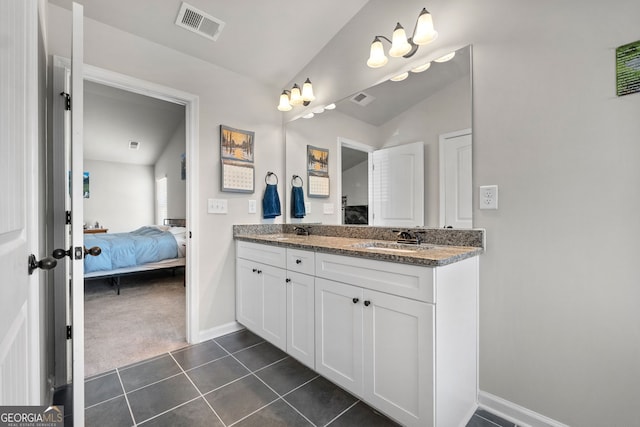 bathroom featuring vanity, vaulted ceiling, and tile patterned floors