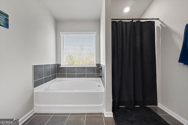 bathroom with a bathtub and tile patterned floors