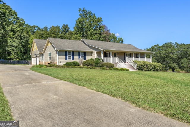 ranch-style home with an outdoor structure, covered porch, a garage, and a front lawn