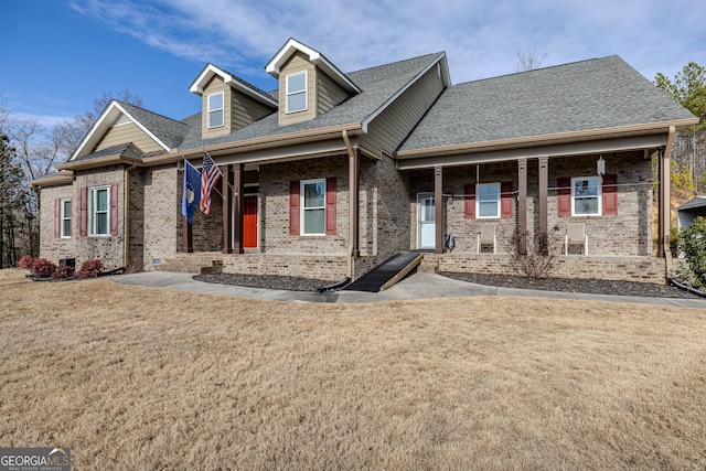 view of front facade with a front lawn and covered porch