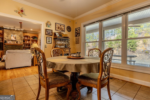 tiled dining area featuring built in shelves and ornamental molding