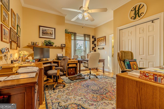 office space with ceiling fan, crown molding, and light wood-type flooring