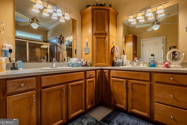 bathroom featuring ceiling fan, vanity, tile patterned flooring, crown molding, and a shower with shower door