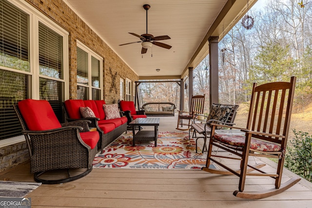 wooden terrace featuring ceiling fan and outdoor lounge area