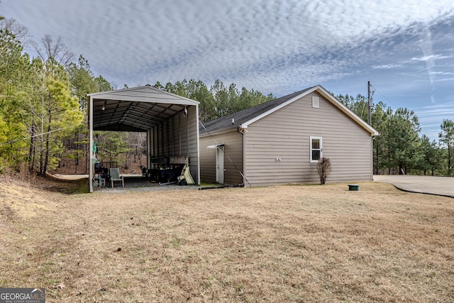 view of property exterior with a yard and a carport