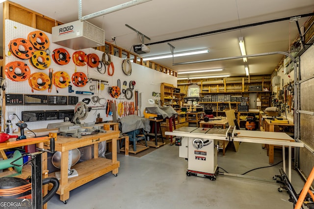 garage with a garage door opener and a workshop area