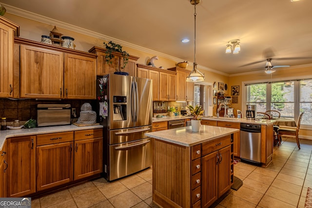 kitchen featuring a kitchen island, pendant lighting, kitchen peninsula, light tile patterned flooring, and appliances with stainless steel finishes