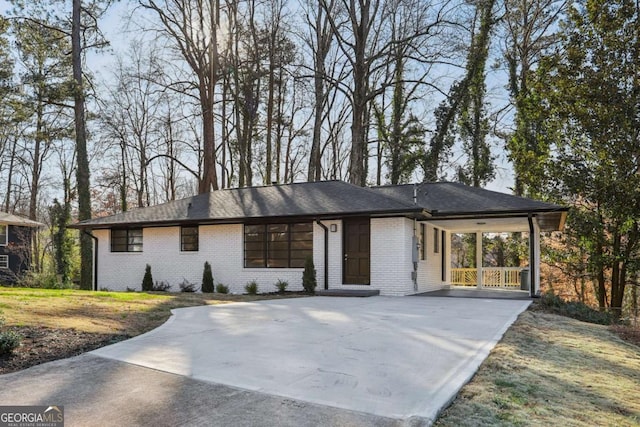 view of front of house with a front lawn and a carport