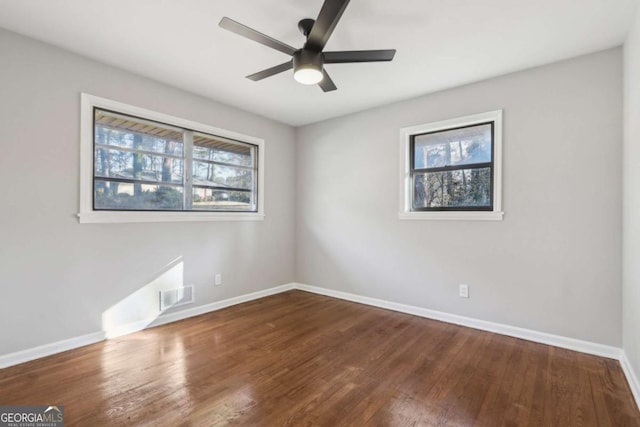 empty room with ceiling fan and wood-type flooring