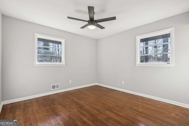 unfurnished room featuring ceiling fan and dark hardwood / wood-style flooring