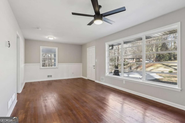 spare room with ceiling fan and dark wood-type flooring