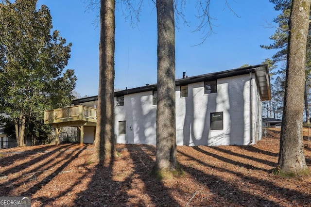 back of property featuring a wooden deck