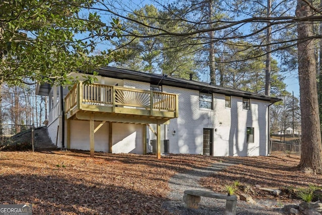 back of house featuring a wooden deck